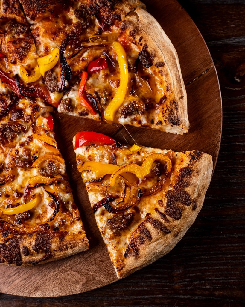 pizza slices with roasted bell peppers and sausage